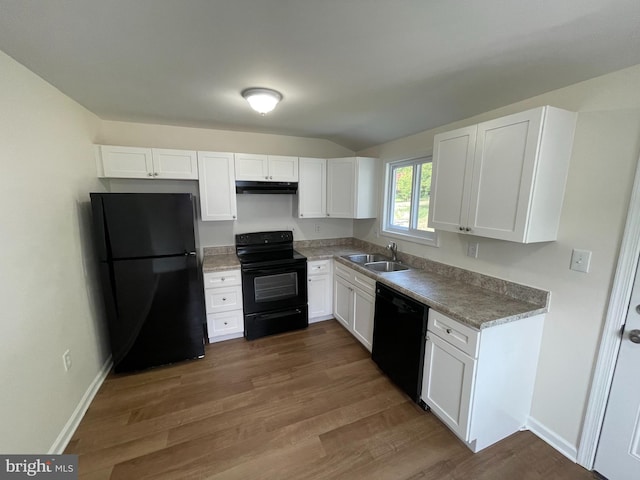 kitchen featuring sink, dark wood-type flooring, white cabinets, and black appliances