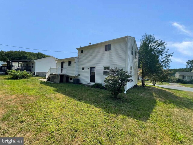 rear view of property featuring a lawn