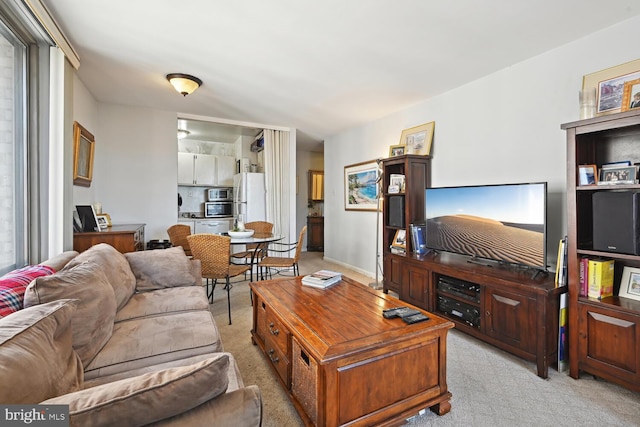 living room featuring a healthy amount of sunlight and light colored carpet