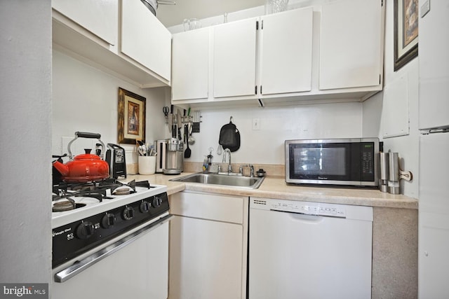 kitchen featuring white appliances, sink, and white cabinets