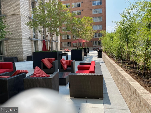 view of property's community with an outdoor living space and a patio