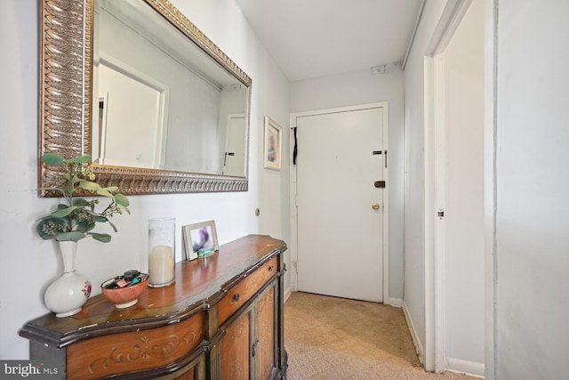 doorway with light colored carpet