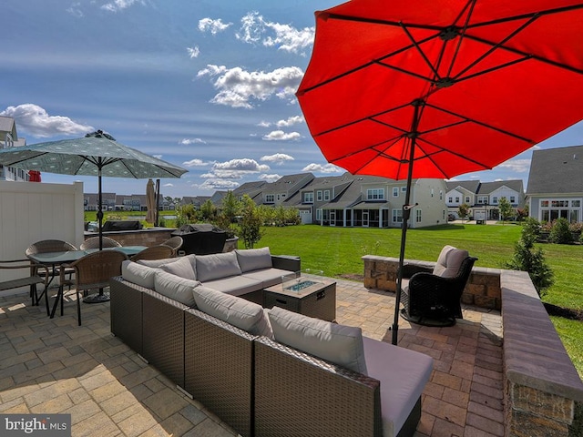 view of patio with an outdoor living space with a fire pit