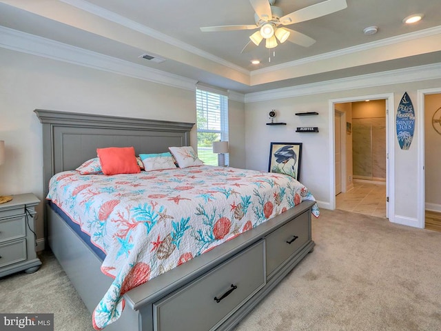 carpeted bedroom with ceiling fan, ornamental molding, and ensuite bath