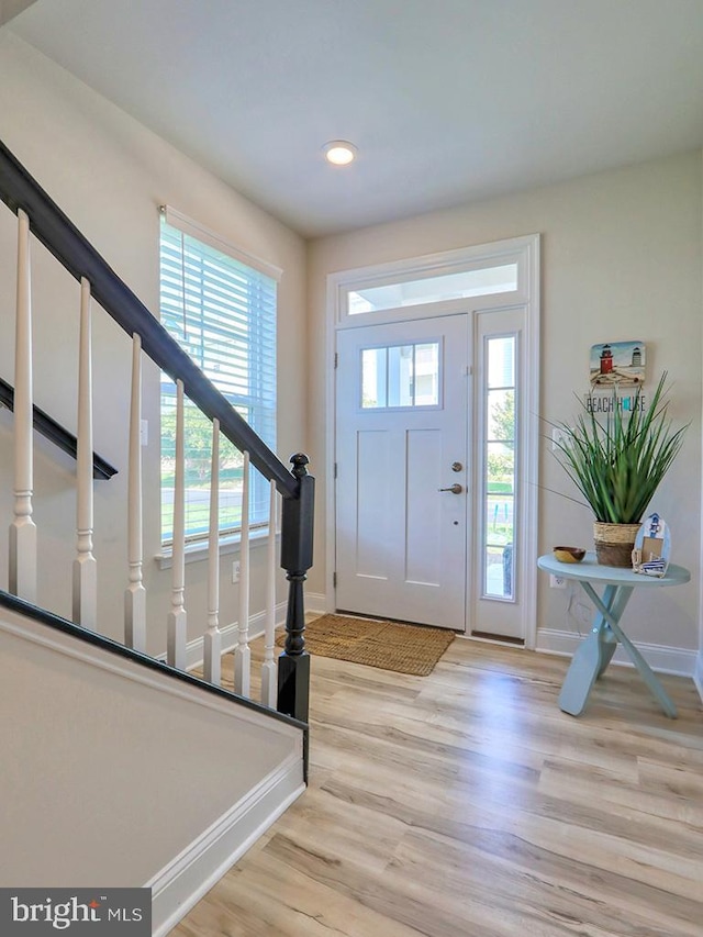 foyer entrance with light hardwood / wood-style flooring