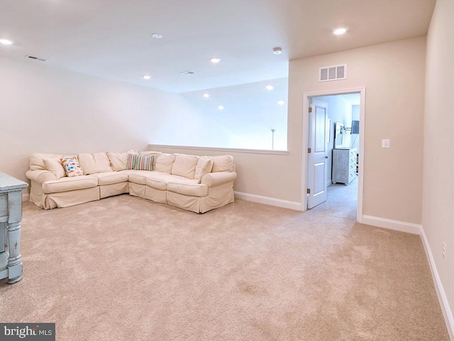 living room featuring light colored carpet, visible vents, baseboards, and recessed lighting