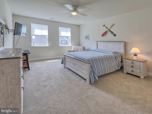 bedroom featuring ceiling fan and light carpet