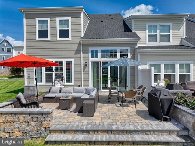 back of house with a shingled roof, an outdoor hangout area, and a patio