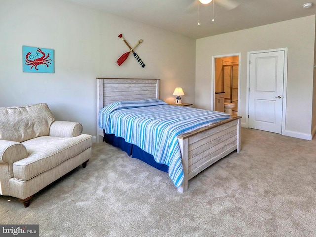 bedroom with carpet flooring, ceiling fan, and connected bathroom