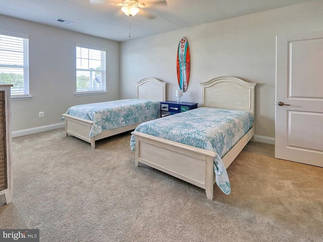 bedroom featuring ceiling fan and light carpet