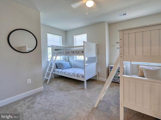 bedroom featuring carpet floors, baseboards, visible vents, and a ceiling fan