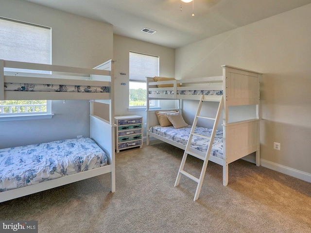 carpeted bedroom featuring multiple windows