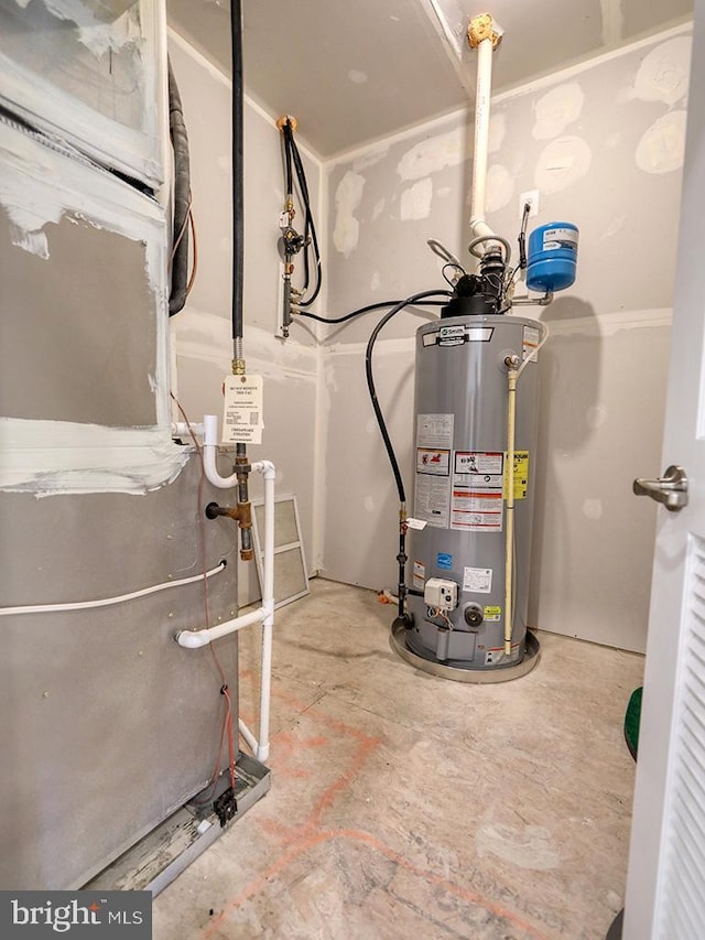 utility room featuring gas water heater and heating unit