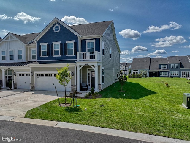 view of front facade with a garage, driveway, stone siding, a residential view, and a front yard