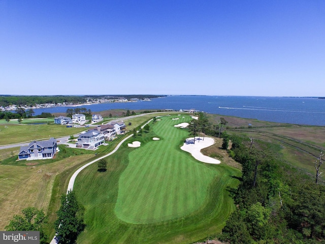 birds eye view of property with a water view and golf course view