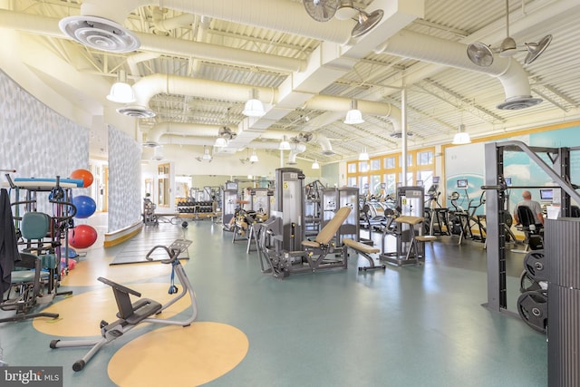 workout area featuring a towering ceiling