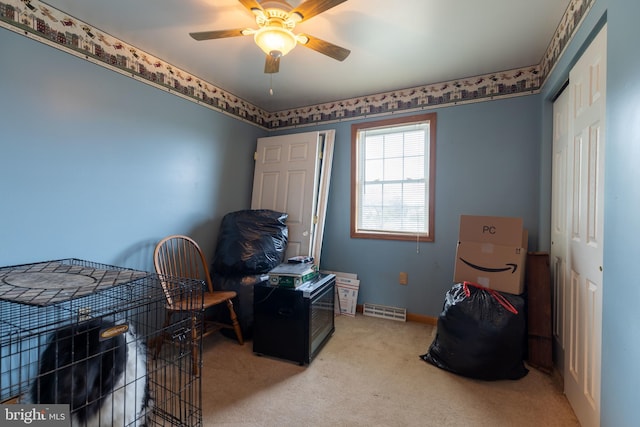 interior space with a closet, ceiling fan, and carpet floors