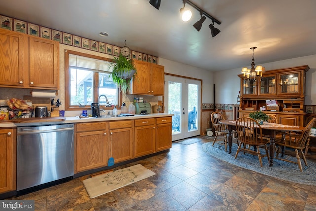 kitchen with pendant lighting, dishwasher, dark tile patterned floors, sink, and french doors