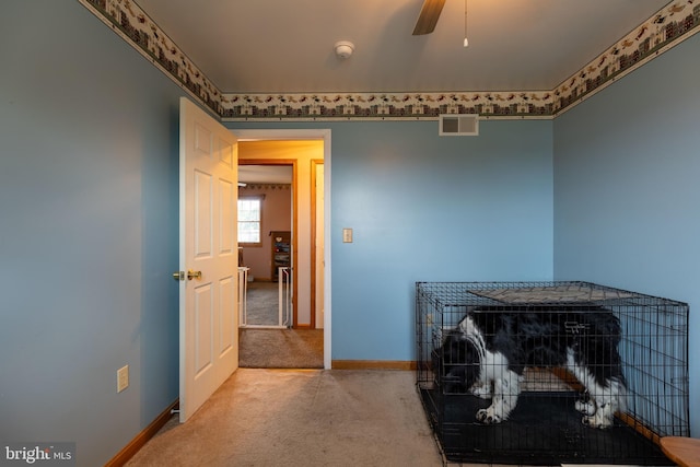 interior space featuring carpet, visible vents, ceiling fan, and baseboards