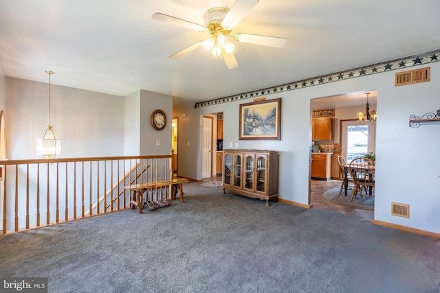 empty room with carpet flooring, visible vents, and baseboards