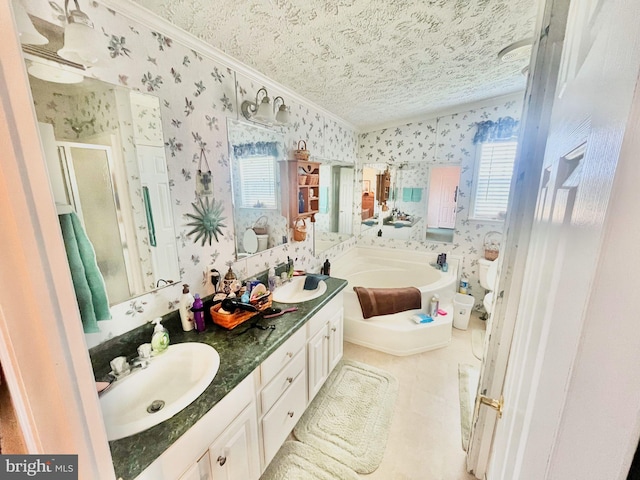 bathroom with tile patterned floors, independent shower and bath, vanity, and a healthy amount of sunlight