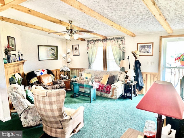 carpeted living room with a textured ceiling, ceiling fan, and beamed ceiling