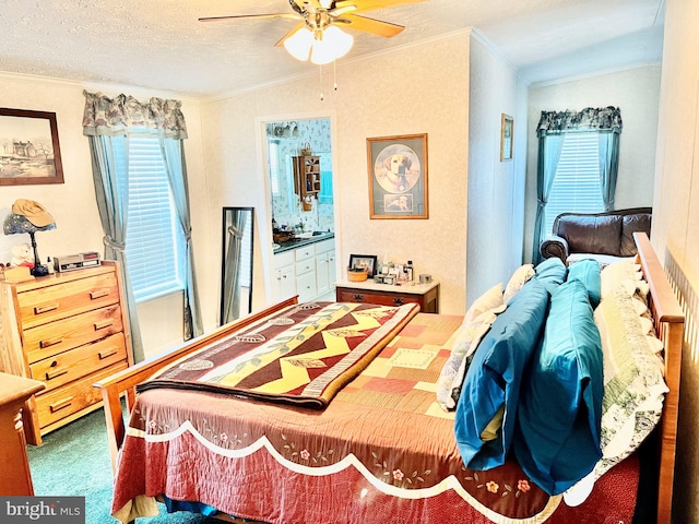 carpeted bedroom with a textured ceiling, ceiling fan, connected bathroom, and ornamental molding