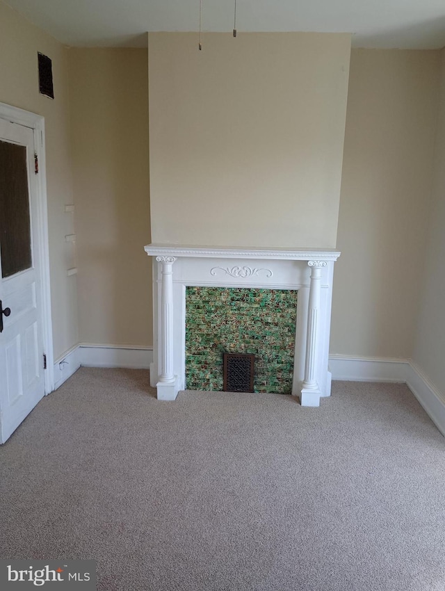 unfurnished living room featuring light colored carpet