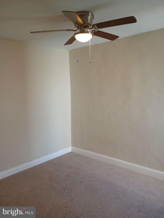 spare room featuring carpet flooring and ceiling fan