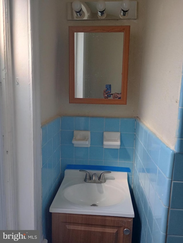 bathroom featuring tile walls, backsplash, and vanity