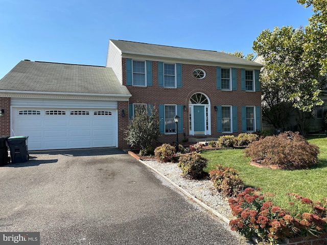 view of front of home featuring a garage and a front lawn