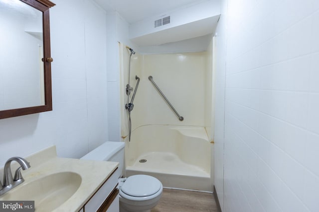 bathroom with walk in shower, vanity, toilet, and hardwood / wood-style flooring