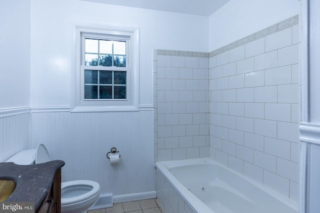 bathroom with vanity, tile patterned flooring, toilet, and a bath