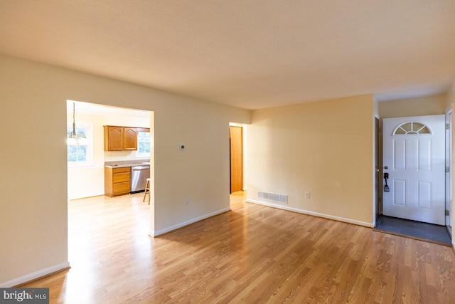 unfurnished living room featuring light hardwood / wood-style flooring