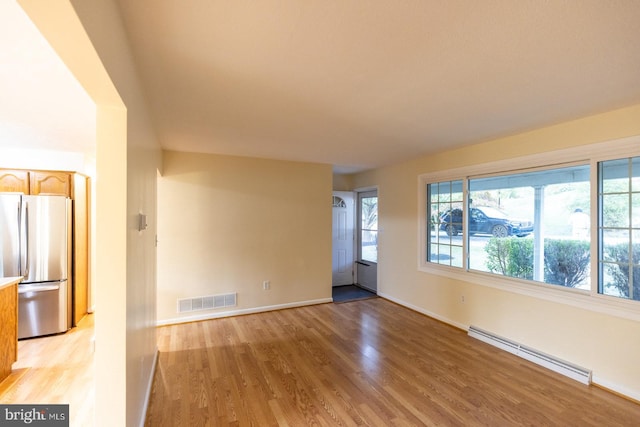 interior space featuring a baseboard radiator and light hardwood / wood-style flooring