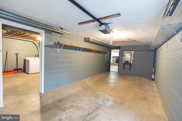 garage featuring a garage door opener and washer / dryer