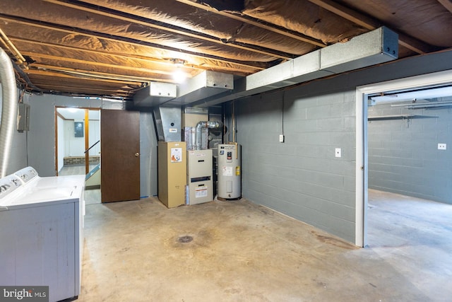 basement featuring water heater, independent washer and dryer, and electric panel