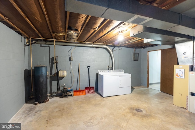 basement featuring water heater and independent washer and dryer