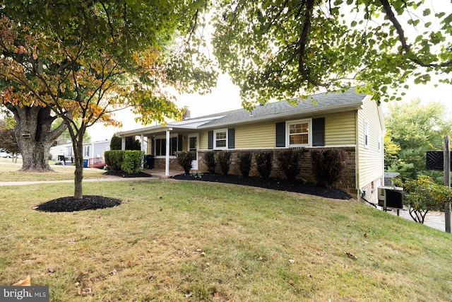 ranch-style home featuring a front yard and central air condition unit