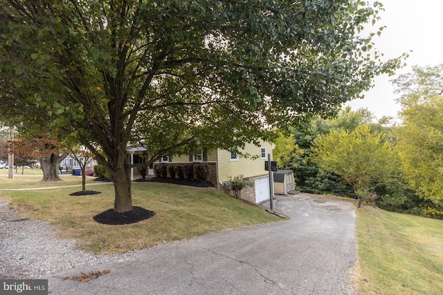 obstructed view of property featuring a front lawn