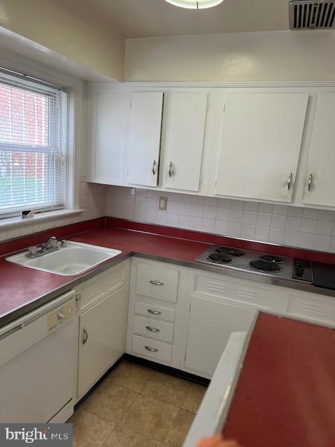 kitchen featuring white dishwasher, white cabinetry, tasteful backsplash, and sink