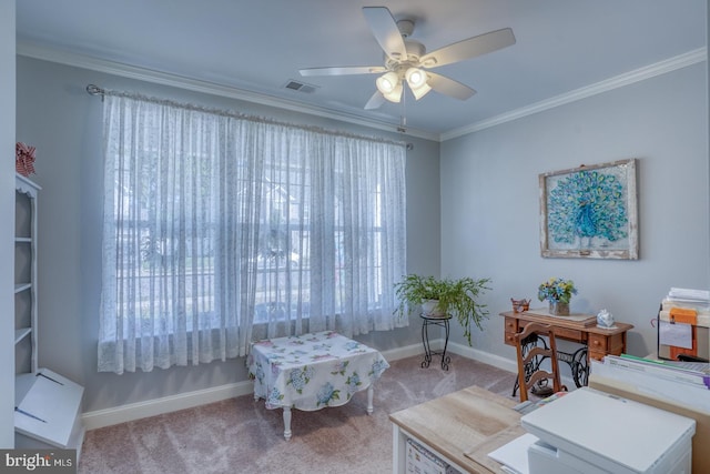 office area featuring visible vents, ornamental molding, a ceiling fan, light carpet, and baseboards