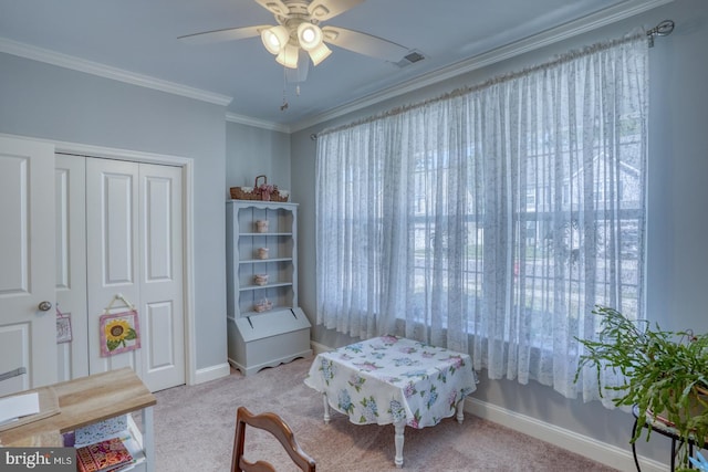 living area with light carpet, visible vents, baseboards, ceiling fan, and ornamental molding