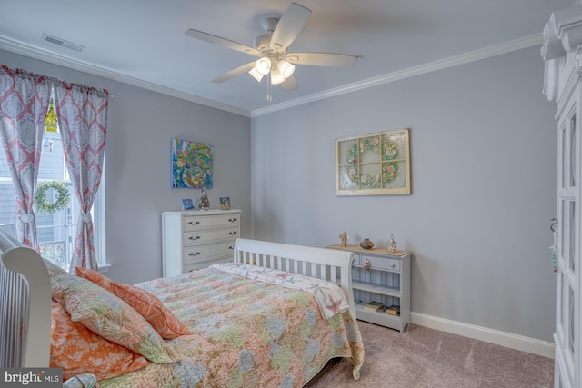 bedroom featuring ceiling fan, light colored carpet, visible vents, baseboards, and crown molding