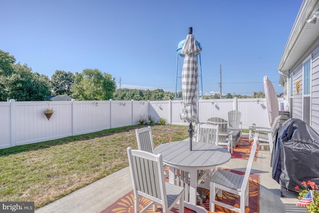 view of patio / terrace featuring outdoor dining space, a fenced backyard, and a grill