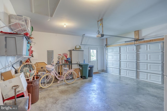 garage featuring a garage door opener and electric panel