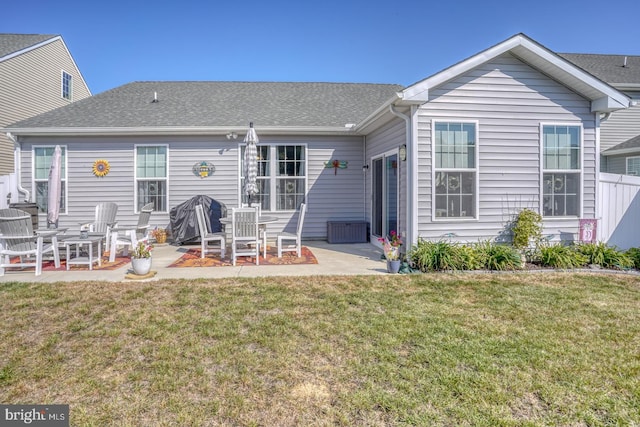 back of house featuring a patio and a yard