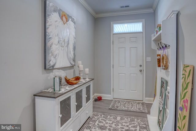 foyer entrance with hardwood / wood-style floors and crown molding