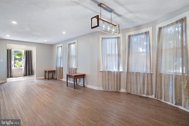 interior space featuring wood finished floors, visible vents, and baseboards