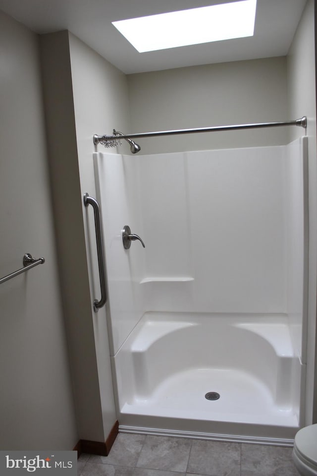 bathroom with toilet and tile patterned floors